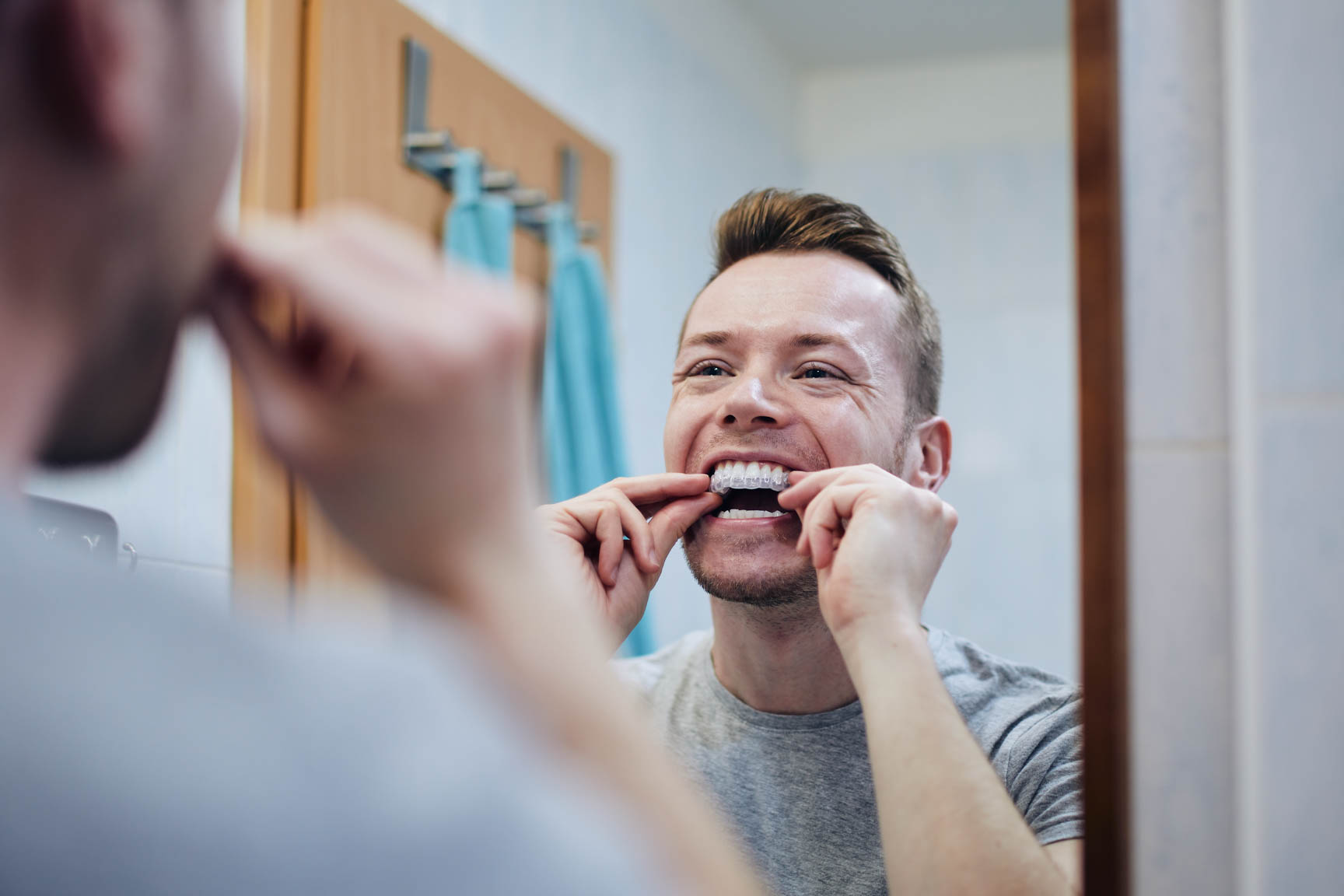 Patient holding clear aligners
